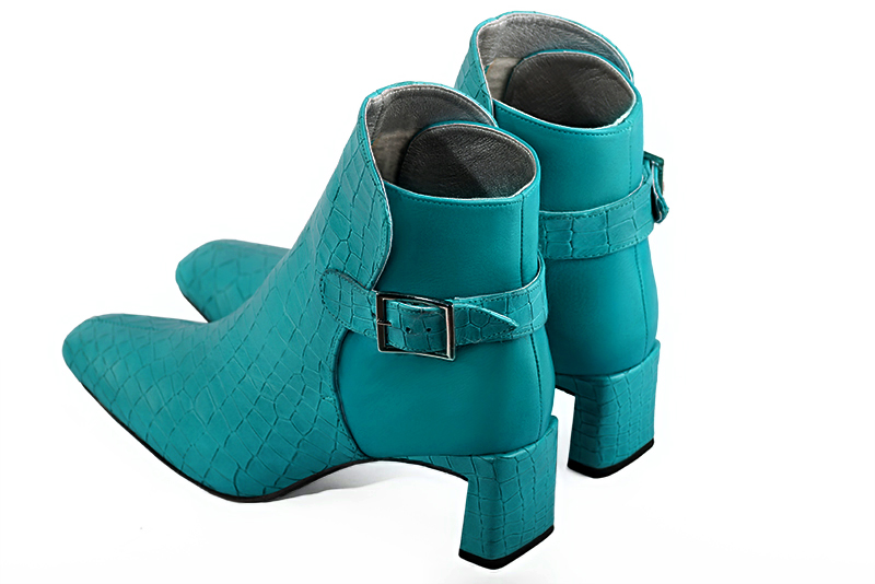 Turquoise blue women's ankle boots with buckles at the back. Square toe. Medium flare heels. Rear view - Florence KOOIJMAN